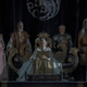 King Jaeherys sits on the ancestral seat of the Targaryens and other members of his family flank him.